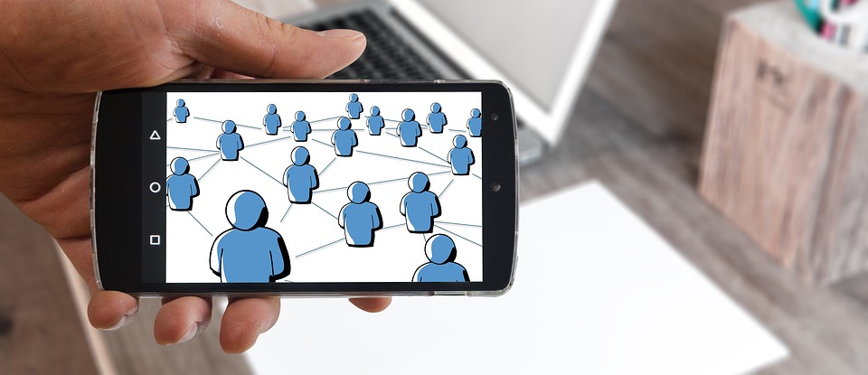 iPhone displaying an image: figures of people connected together.