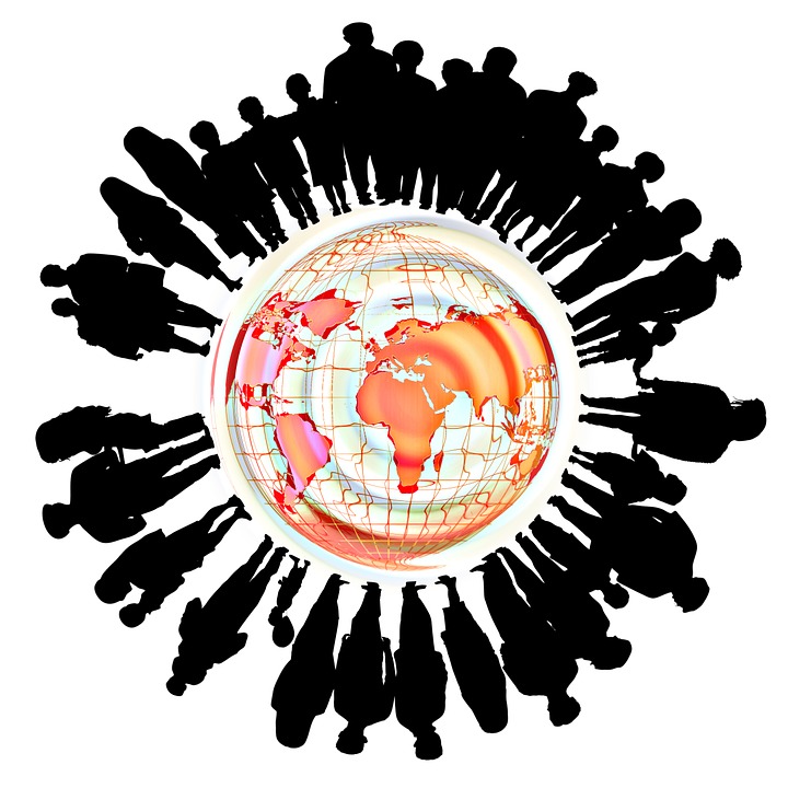 Picture of people standing around the Earth to illustrate international customer service tips.