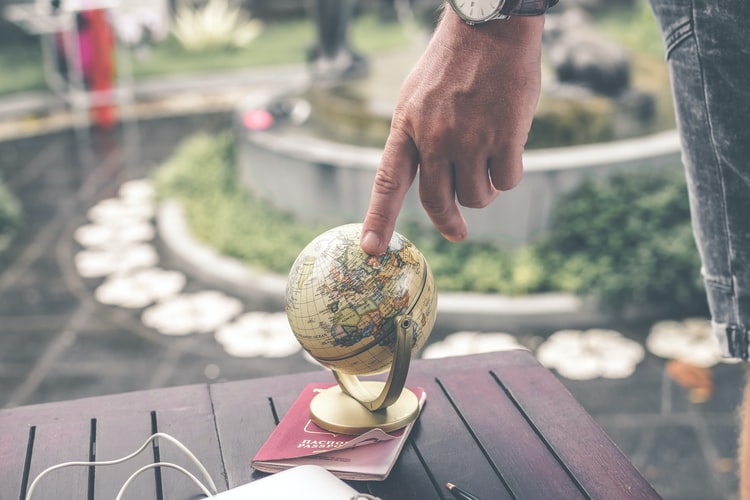 Man pointing at globe