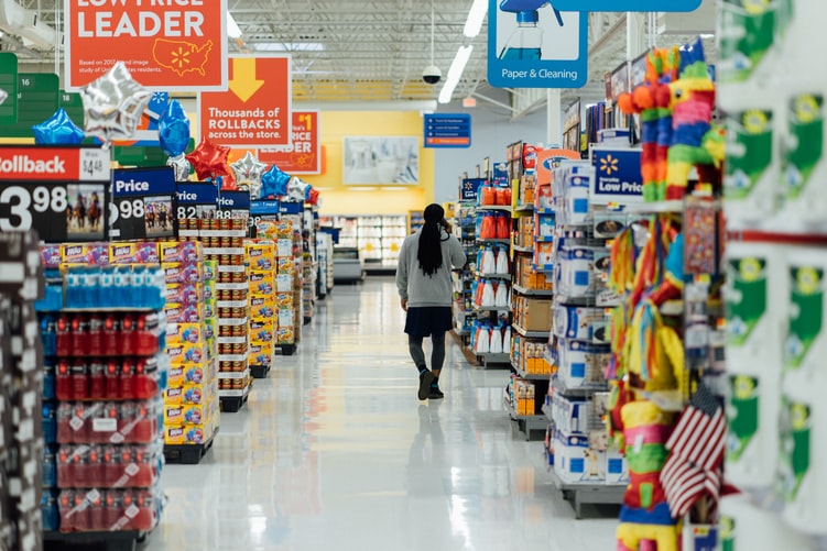 Person walking through supermarket, illustrating e-commerce growth