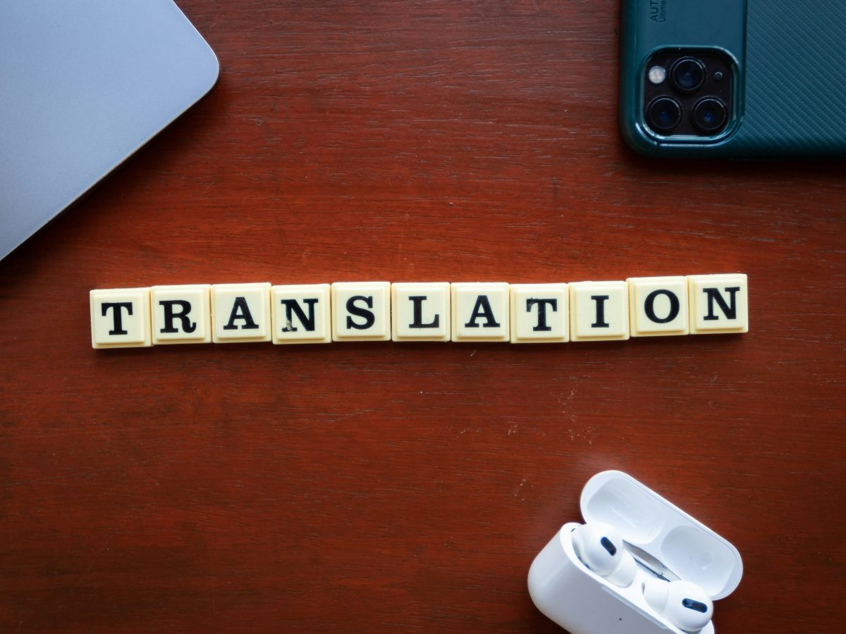 The word 'translation' is spelt out using scrabble style letter tiles