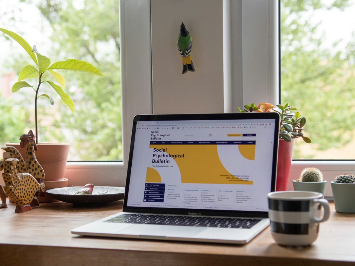 Website displayed on a laptop, on a desk.