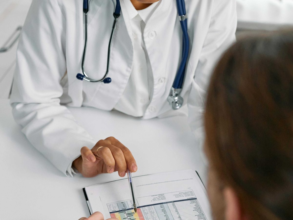 Medical professional filling out a survey with a patient