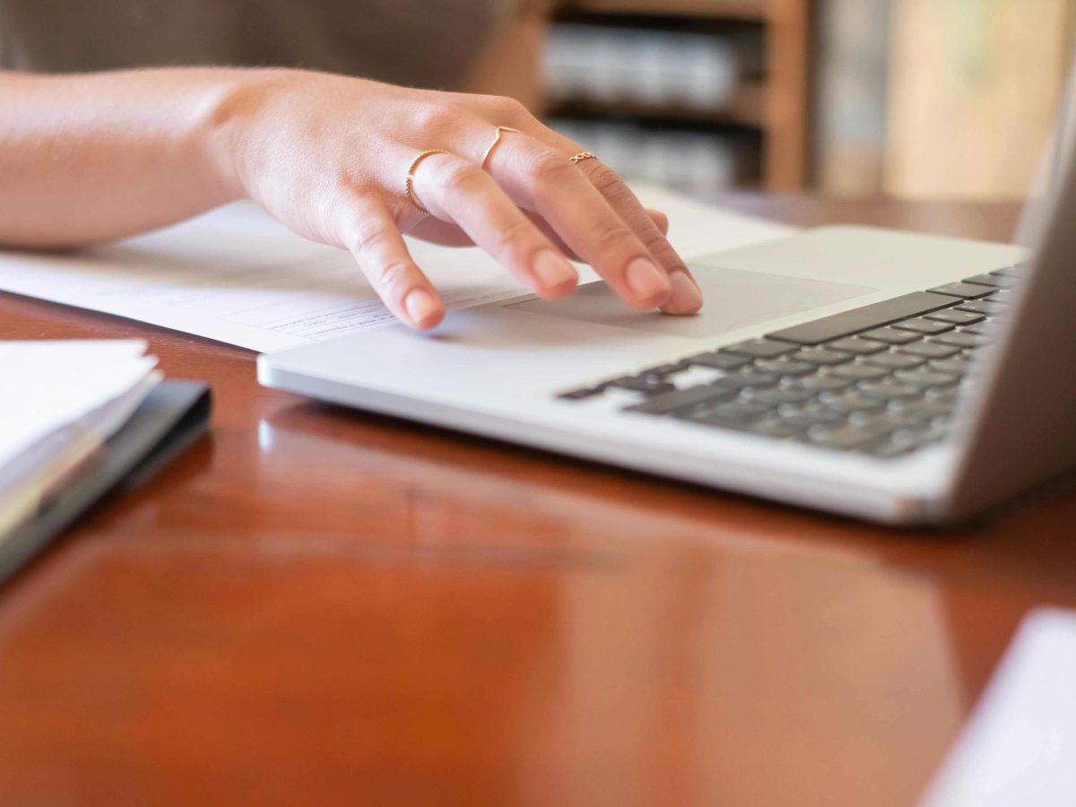 Person typing on computer. Credit to Glenn Carstens Peters.
