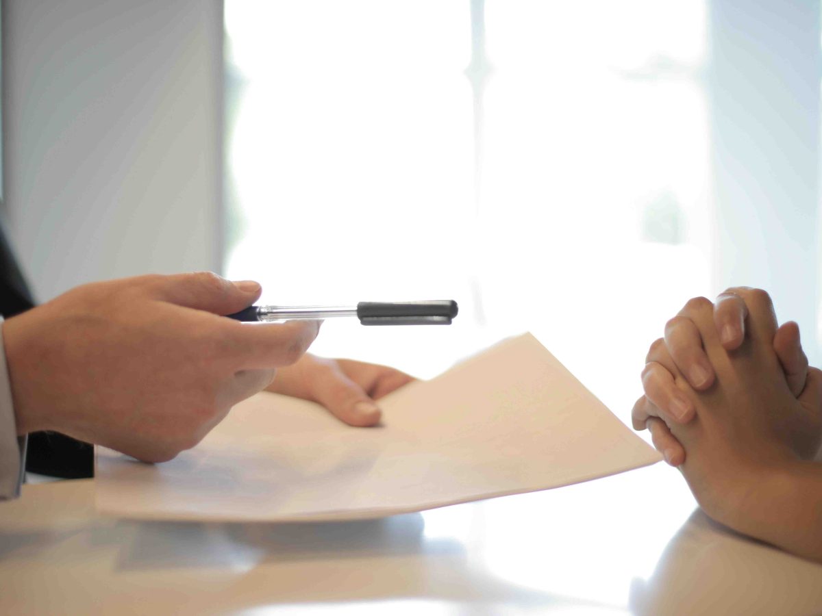 Close up photo of someone writing on documents.