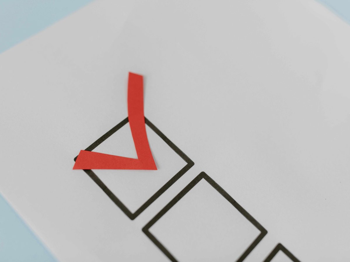 A big red tick in a box on a paper.