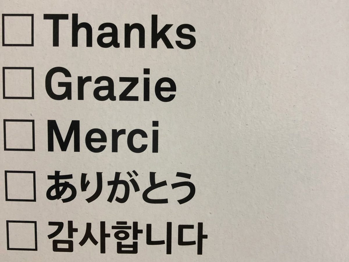 A sign with multiple language options